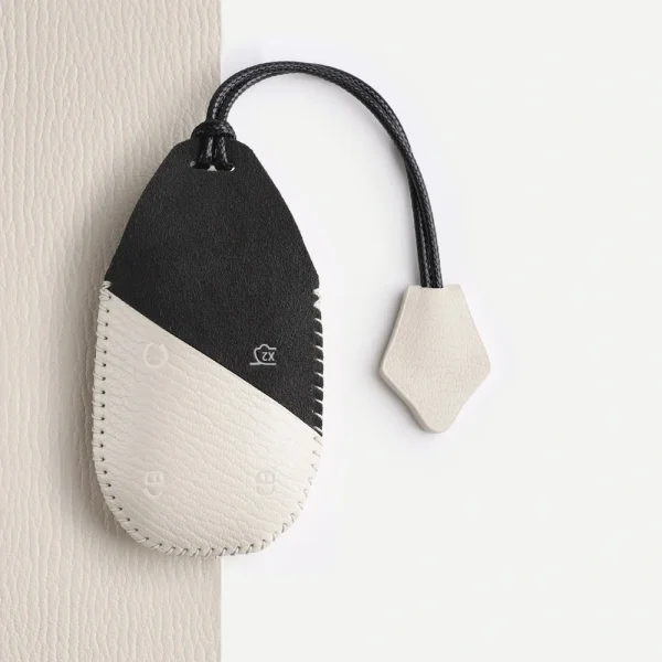 Ivory White Hand Strap key cover showing the complete cord, leather tag and stitching